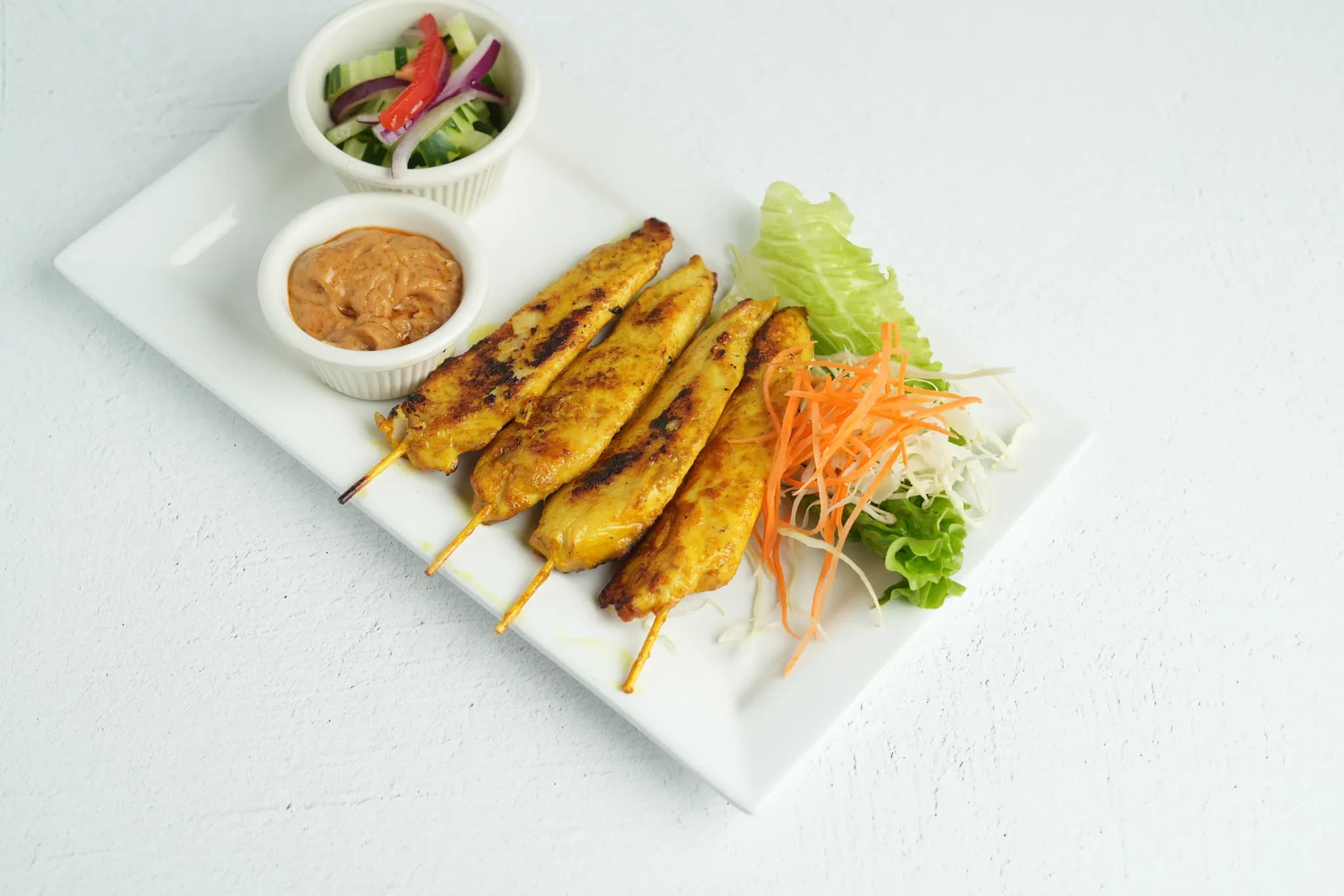 Satay Chicken or Satay Tofu (4 skewers) plated at Maly Thai restaurant in St. Charles